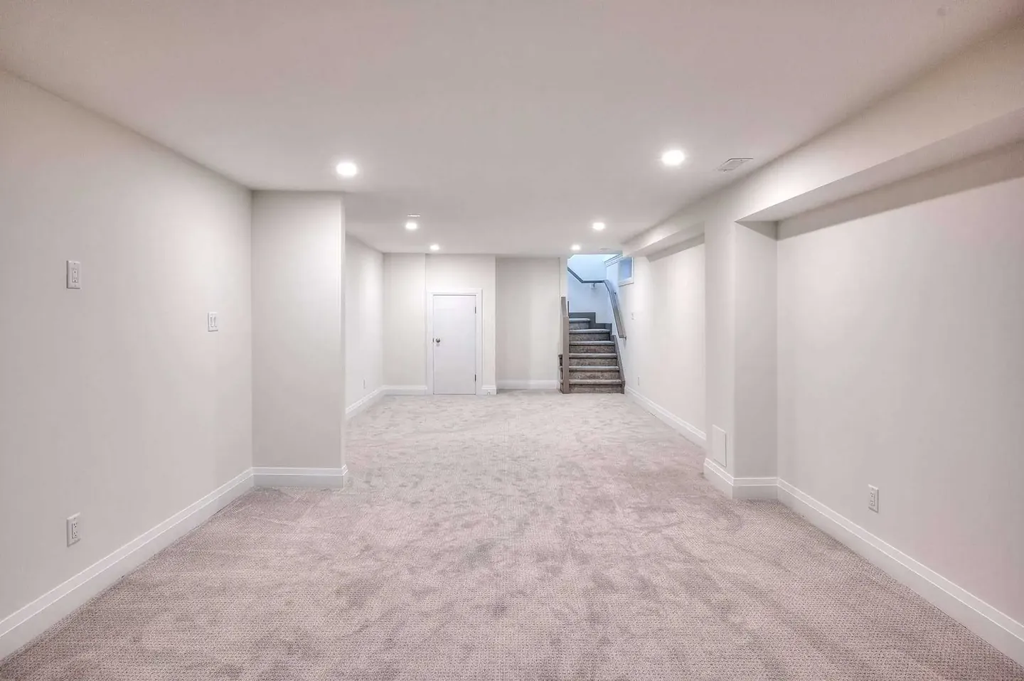 Finished basement with carpet, pot lights and a new staircase