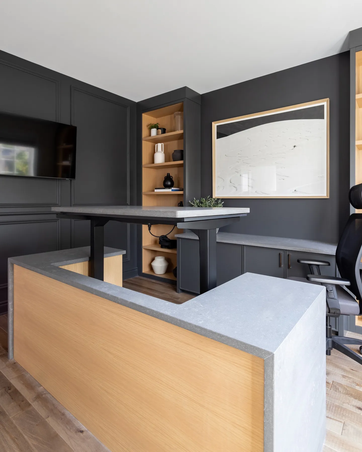 Home office desk with charcoal millwork and open oak shelving